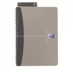 The photo shows a grey Oxford Wirebound Oxford notebook with a wirebound polypropylene cover. It contains 180 ruled pages with a smooth, metallic finish. The A4 size and 90gsm weight make it perfect for any office setting.