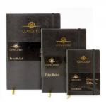 This photograph features three Concord Noir (A6) notebooks with a flexible cover. Each notebook contains 160 pages made of 90gsm paper and has 8mm feint ruled lines. The cover design is a sleek black color, accented with the Concord logo. The pages inside are neatly lined and ready to be filled with notes or drawings. The compact size makes these notebooks perfect for on-the-go use.