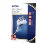 The photograph captures a pack of 15 sheets of Epson A4 Ultra Glossy Photo Paper, with a weight of 300gsm. The paper is in a bright white color, displaying a smooth and glossy surface. The Epson logo is visible on the packaging, indicating the brand.