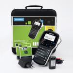 The image shows a compact, handheld label maker with a sleek, black design. The screen displays clear, crisp text for easy label creation. The kit includes a protective case for convenient storage and transportation.