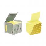 The photograph shows a stack of Post-it concertina sticky notes with a cardboard packaging, made of recycled materials, in the size of 76 x 76mm. The notes are in the signature canary yellow color and come in a pack of six.