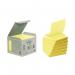 The photograph shows a stack of Post-it concertina sticky notes with a cardboard packaging, made of recycled materials, in the size of 76 x 76mm. The notes are in the signature canary yellow color and come in a pack of six.