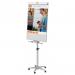 The image shows a sleek ACCO Brands Flipchart Easel & Pads Nobo Classic Nano Clean™ Mobile Easel 1902386. The easel stands tall and sturdy, with a clean white surface ready for use. The frame is made of metal and features smooth curves and a modern design. The easel is mobile, with wheels attached to the bottom, making it easy to move around as needed. The accompanying flipchart pad is neatly placed on a tray at the top of the easel. The overall look exudes professionalism and functionality.