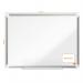 This picture shows an ACCO Brands Drywipe Board, specifically the Nobo Premium Plus Melamine Whiteboard in size 600x450mm. The whiteboard is wall-mounted and has a sleek silver frame. The melamine surface is smooth and glossy, providing a clear writing and erasing experience. The board is surrounded by a thin black border and has a built-in marker tray at the bottom. There are several magnets attached to the surface, holding up important papers and notes. In the background, a few chairs and a desk can be seen, suggesting this whiteboard is being used in a professional office or educational setting.