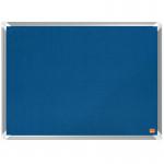 In the image, I see a blue Nobo Premium Plus felt notice board from ACCO Brands. The board measures 600x450mm and has a smooth, high-quality surface. The blue color adds a touch of vibrancy to the board, making it stand out in any room. Some notes and papers are stuck on the board, held in place by silver push pins. The board is mounted on a clean white wall, creating a professional and organized look.