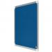 The image shows a blue Nobo Premium Plus felt notice board, measuring 600x450mm. The notice board is made by ACCO Brands and includes their logo in the bottom corner. The felt material has a soft texture and the blue color is vibrant. The edges of the board are framed in silver, giving it a polished look. Various sizes of paper and notes can be seen pinned onto the board, showcasing its functionality. The notice board is mounted on a wall, with a white background.