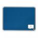 In the photo, there is a blue ACCO Brands Noticeboards Nobo Premium Plus Felt Notice Board measuring 600x450mm. The luxurious texture of the felt is evident as it covers the entire board, providing a smooth surface for pinning notes and important documents. The edges are neatly framed with a durable silver border, adding a touch of sophistication. Various colorful push pins are scattered across the board, holding up a mixture of handwritten reminders and printed materials. In the background, a well-lit wall can be seen, emphasizing the clean lines and modern design of the notice board.