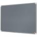 In the photo, the ACCO Brands Noticeboards Nobo Premium Plus Felt Notice Board can be seen in a sleek grey color. The board is 900x600mm in size, providing ample space for displaying important notices and reminders. The premium felt material gives the board a professional look and feel. The smooth surface of the board allows for easy pinning and unpinning of papers. Its durable construction ensures long-lasting use. Overall, the notice board appears to be a sturdy and functional addition to any workspace or classroom.