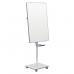 The image shows a mobile magnetic flipchart easel from ACCO Brands. The easel is from the Nobo Move & Meet series and measures 680 x 1040mm. The surface of the flipchart is white and has a smooth texture, perfect for writing and displaying notes. The easel has a sturdy stand with four wheels, making it easy to move around and adjust to the desired height. The flipchart pad is held in place by two clamps at the top and bottom of the easel, ensuring stability while in use. The design is sleek and professional, making it suitable for use in any meeting or presentation setting.