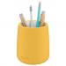 This photo shows a bright, warm yellow Leitz Cosy Pen Pot from ACCO Brands. The pot has a clean, sleek design with a textured surface and a glossy finish. It is filled with various desk supplies, including pens, pencils, and paper clips. The pot is surrounded by other matching desk accessories, creating a tidy and organized desk space.