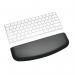 The picture shows a wrist rest designed by ACCO Brands, specifically for slim and compact keyboards. The wrist rest is made by Kensington and is called the ErgoSoft™ Wrist Rest. It features a sleek design and is made with soft materials to provide comfortable support for the wrists while typing. The rest is designed to fit seamlessly with slim keyboards, providing ergonomic benefits for users. The picture showcases the high-quality construction and attention to detail put into the design of this wrist rest.