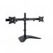 This photograph features a sleek, modern monitor arm from ACCO Brands with a free-standing base for dual-monitor support. The arm is made by Kensington and boasts a sturdy design with a shiny silver finish. The dual arms can be adjusted for maximum ergonomic comfort while working.