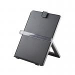 The picture shows a sleek black Fellowes document holder on a workstation. It has a sturdy base and adjustable arms to hold papers in place while typing. Perfect for keeping your workspace organized and efficient.
