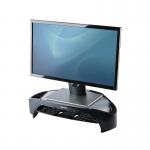 The picture shows a sleek black and silver Fellowes Smart Suites Monitor Riser Plus, with a corresponding dust cover, designed to elevate and protect your monitor.