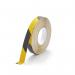 This picture features a yellow and black DURALINE GRIP floor marking equipment, measuring 25mm in width. The durable design can withstand frequent use and provide long-lasting markings on any surface.