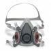 The image shows a 3M half mask from the 6000 series, specifically the model 3M6200M. The mask covers the lower half of the face and has straps that go around the head and neck for a secure fit. The mask is made of durable material and features a small 3M logo on the side. It is designed for protection in various work settings.