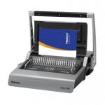 This image shows a Fellowes Binding Galaxy Manual Comb Binder in action. The sleek black machine is open, with a comb inserted in the comb opener. Sheets of papers lay on the side waiting to be bound. The binding handle is being pressed down, closing the comb and securing the papers together.