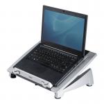 The photo shows a sleek, black laptop stand from Fellowes Office Suites collection. It features adjustable height settings and a removable tray for storage. The stand is angled to promote ergonomic viewing and has a built-in cable management system. Perfect for any modern office setup.