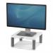 In the photo, there is a sleek and modern Fellowes monitor stand with a platinum finish. It also includes a dust cover to keep your monitor clean and protected. The stand raises the monitor, providing a more ergonomic viewing angle.