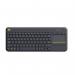 This picture shows a sleek and compact Logitech wireless touch keyboard. It has a black matte finish and full-sized keys. The trackpad is integrated for easy navigation.