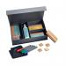 This photograph captures the Sigel Drywipe Accessories Starter set, including 4 markers, 4 wooden magnets, 1 board eraser, spare pad, magnetic cleaning cloth, and cleaning spray. The set is neatly arranged on a wooden board, showcasing its variety of useful tools.
