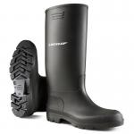 The photograph features a pair of durable and versatile black Dunlop Pricemastor PVC Non-Safety Wellington Boots. The boots have a sleek and glossy finish with a classic design and can be seen standing on a rugged surface, ready for any outdoor task.