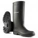 The photograph features a pair of durable and versatile black Dunlop Pricemastor PVC Non-Safety Wellington Boots. The boots have a sleek and glossy finish with a classic design and can be seen standing on a rugged surface, ready for any outdoor task.
