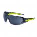 The photo shows a pair of Bolle Safety Spectacles in a sleek design. The lenses are tinted smoke and the frame is made of durable materials. The glasses have a comfortable fit and offer reliable protection for the eyes.