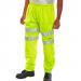 The photograph shows a pair of Beeswift High Visibility Jogging Bottoms in a bright Saturn Yellow color. The pants have a comfortable fit and feature reflective stripes for increased visibility while jogging.