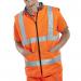 The photo shows two Beeswift high visibility bodywarmers in orange and grey, one side reversible, with the Beeswift logo on the chest. The bodywarmers are lined with soft fabric and have a zipper closure. They have reflective strips on the front and back for added visibility.