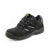 A photograph of Beeswift Safety Trainers Beeswift Trainer Shoe Black 9 CDDTB09 shows a sleek and sturdy black shoe with a reinforced toe and gripped sole. The trainers have a low ankle height and feature the Beeswift logo on the side. The material appears durable and built for safety and functionality.