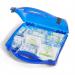 The photo shows a compact first aid kit designed for kitchen or catering use, with a bright red case and a clear First Aid label. The case opens with a simple click mechanism, revealing neatly organized medical supplies and instructions for 21-50 people.