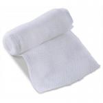 The photograph shows a small first aid dressing by Click Medical, with a compact size and simple design. The packaging is labeled with the product name and company logo, and the dressing itself appears to be made of sterile, white material. It has a smooth, flat surface and is neatly folded, ready for use in a medical emergency.
