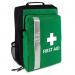 The photograph shows an empty first aid bag, specifically a first aid rucksack with a detachable kit. The bag is made of sturdy material and features multiple pockets and compartments for organizing supplies. The detachable kit adds additional storage space. The bag is compact and has adjustable straps for comfortable carrying.
