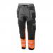 A photo of Beeswift High Visibility Trousers shows a bright orange and black two-tone design. The trousers are made of durable material and have a high visibility feature for safety. The size is 30T.