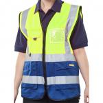 The photograph shows Beeswift high visibility vests, specifically a two tone executive waistcoat in Saturn Yellow and Navy. This 2XL vest is designed for maximum visibility and features the Beeswift logo on the chest. The color contrast adds a professional touch while ensuring safety in low light situations.