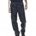 This photo shows a pair of navy blue Beeswift nylon B-DRI trousers in size XL. The trousers have a sleek, shiny finish and feature two large front pockets, adjustable waistband, and zippered ankles. Bold Beeswift branding can be seen on the side of the leg. Perfect for staying dry and comfortable in wet weather.