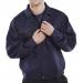 In the photograph, a navy blue Beeswift Heavyweight Drivers Jacket can be seen. The jacket style is specifically designed for drivers and is a size 46. The material appears thick and sturdy, ideal for outdoor work. The brand name Beeswift can be seen boldly displayed on the jacket.