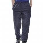 The image shows a pair of navy blue Beeswift Springfield trousers in size XL. The trousers have a straight leg fit and are made of durable material. The fly is secured with a zipper and button, and there are multiple pockets on the front and back. The waistband is adjustable for a comfortable fit.