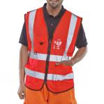 The picture shows a red Beeswift executive high visibility waistcoat in size 4XL, designed for optimal visibility in various work environments. The vest features the Beeswift logo and reflective strips for enhanced safety.