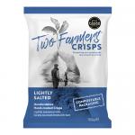 A cardboard multipack holds twelve 150g bags of Two Farmers Lightly Salted crisps, arranged in two neat rows. Each bag shows the Two Farmers logo, a pale green and cream color scheme, a photo of golden potato chips, ingredient icons and small text along the edges. Fine salt flecks dust a few chips.