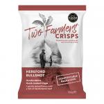 Photograph shows a cardboard case containing twelve Two Farmers crisps packs, each 150g. Bags display a stylized Hereford bull illustration, red and cream branding, bold 'Bullshot' lettering. Several crisps lie scattered in front, with natural lighting and a rustic wooden surface. Soft shadows fall.