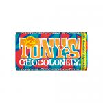 A colorful display of fifteen Tony's Chocolonely milk chocolate chip cookie bars, each wrapped in bright packaging. The bold Tony's logo and uneven-segment chocolate illustration dominate the front. Fairtrade emblem and cookie-chunk graphics add texture and contrast. Subtle gloss reflects very dimly