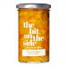 Six glass jars of Ploughboy chutney sit neatly in a cardboard tray; deep amber chutney glows through clear glass. Cream labels feature bold blue logo 'The Bit on the Side', rustic typography and small vegetable illustrations. Metal lids reflect studio lighting. Soft shadows on pale wood. Dewy beads.