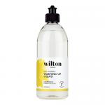 Six clear 500ml bottles of Wilton London Eco washing-up liquid stand in a neat row, showing translucent pink grapefruit liquid. Each bottle bears a green-and-white label with a grapefruit illustration and eco icon, topped with white flip caps. Soft studio lighting creates gentle reflections. Subtle.