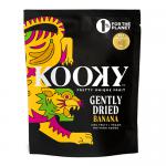 A bright yellow pouch of Kooky Gently Dried 100% Banana shows a clear window revealing irregular, golden banana slices. The bold Kooky logo appears at the top with playful fruit illustrations. Ingredient text and weight appear in small print along the bottom and sides. Matte finish with silver tear.
