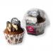 Photo shows six vanilla woofins with smooth carob frosting neatly arranged in a pastel box. Each paw-shaped treat displays creamy pale cake and glossy dark-brown frosting. Branded packaging rests beside them, featuring playful typography and a small paw-print logo. A faint vanilla aroma seems to rise.