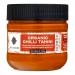 A clear PET bottle of Med Cuisine Organic Chilli Tahini shows a smooth, creamy beige paste streaked with red chili flecks. Twelve identical 200g bottles sit in neat rows; each front-facing label displays the Med Cuisine name and product title against a simple, clean design. With a visible screw cap.