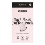 Photograph shows a rectangular refill box of Grind Coffee Roasters pods. Matte black packaging features a bold white logo and dark roast label. The compact box displays a home-compostable icon, weight 90g and a 10 x 10 quantity line, sitting on a neutral surface. Soft studio lighting highlights matte