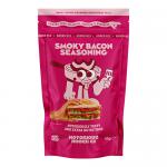 Image shows twelve 80g tubs of Notorious Nooch Smoky Bacon Seasoning arranged in neat rows; each bright label features the Notorious Nooch logo, smoky-brown bacon graphics and the flavor name, with visible caps, jar rims and ingredient/nutrition panel text.
